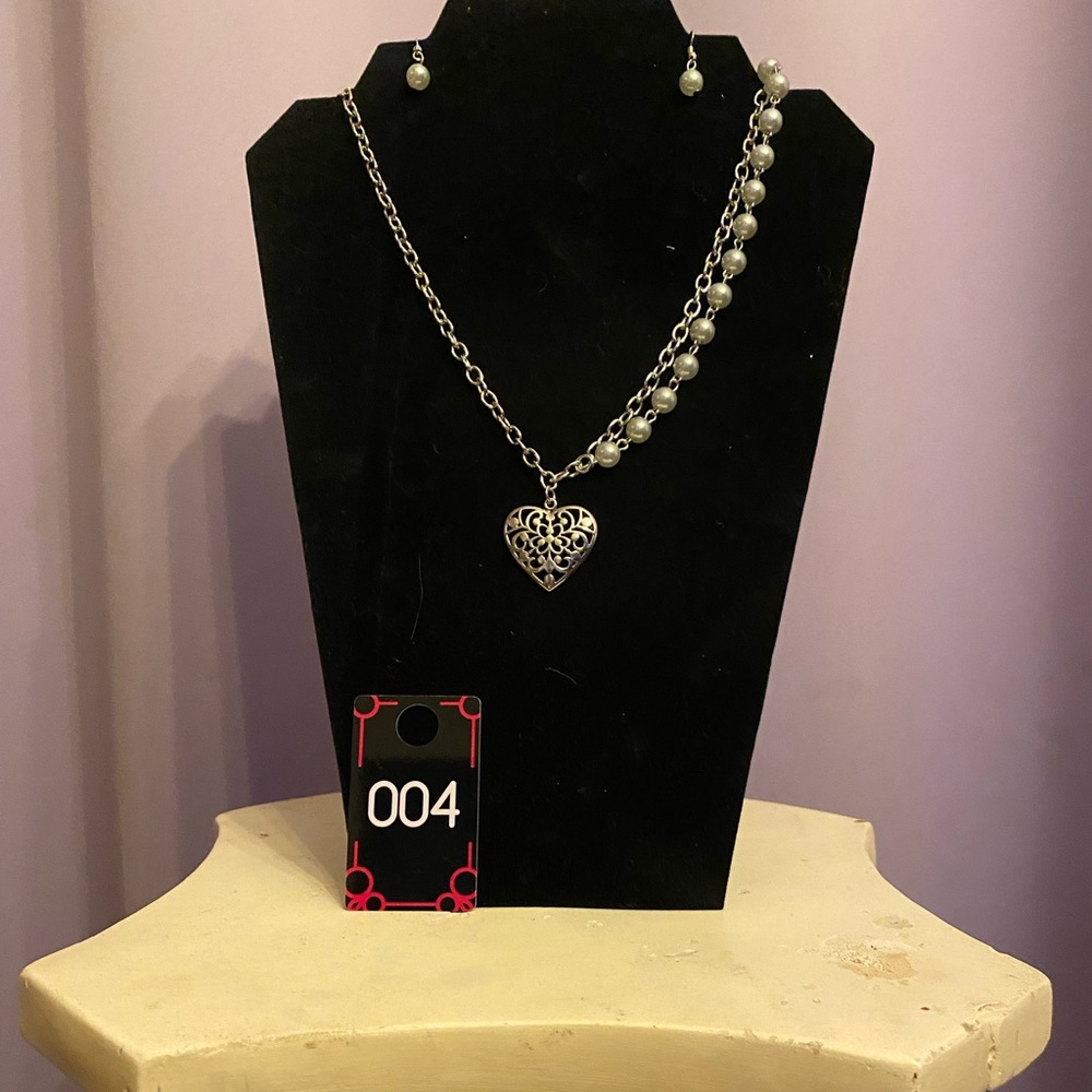 This lovely necklace has a unique hanging, with white Pearl like beads on 1 side